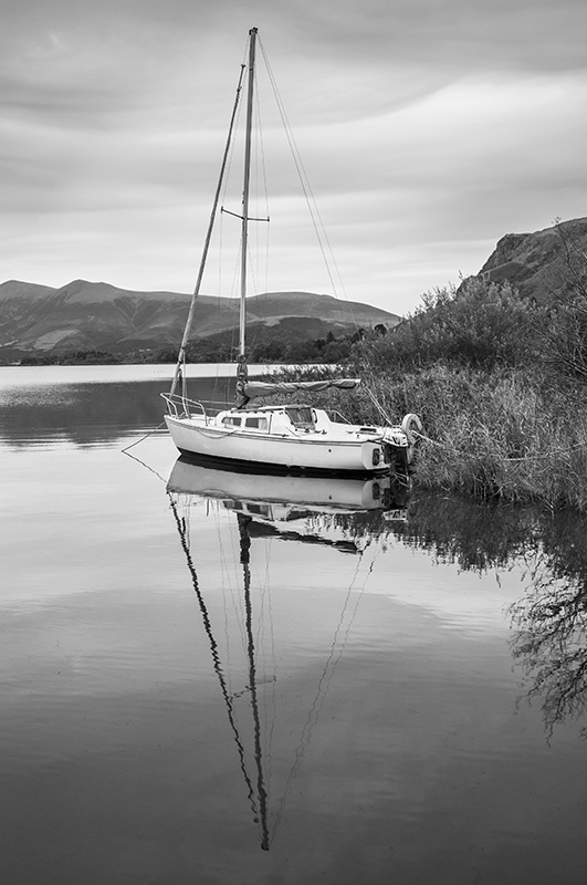 A sailing boat moored up on Derwent Water UK